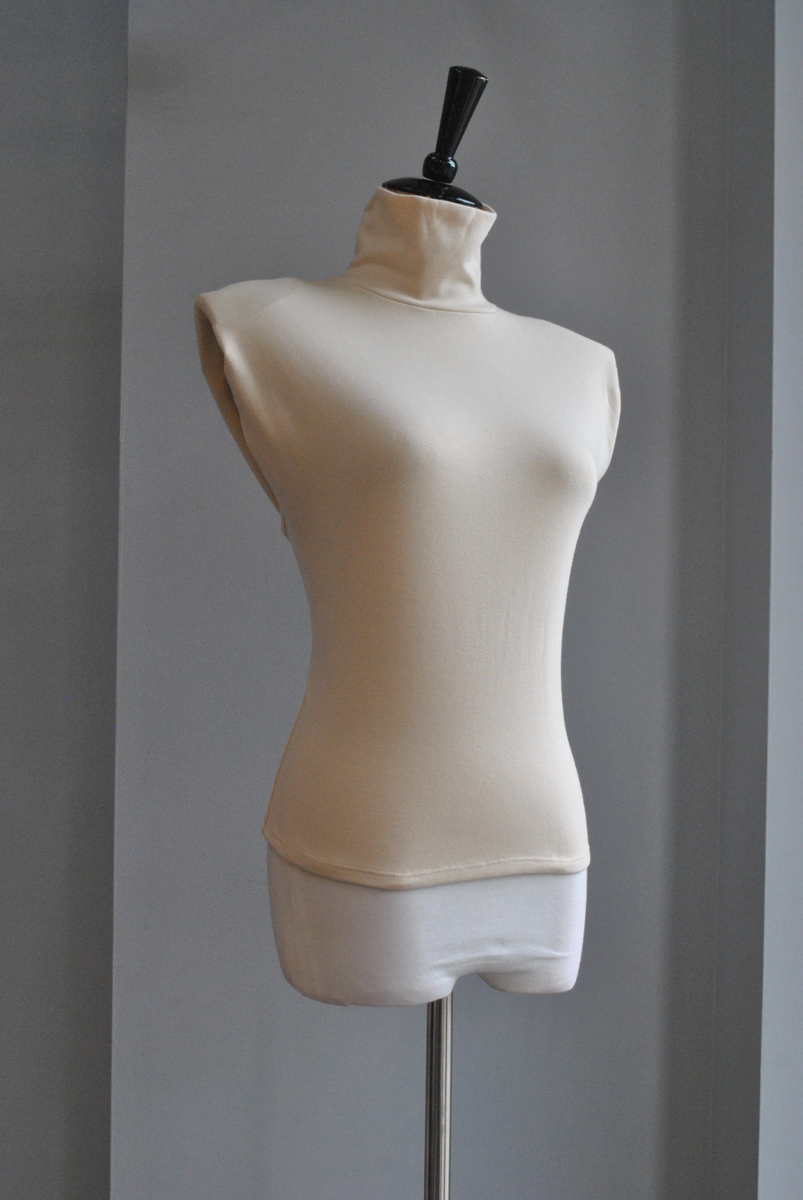 LIGHT CREAM TOP WITH HIGH NECK AND PADDED SHOULDERS